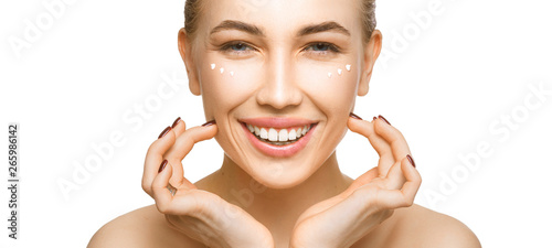 Woman touching her face by hands. Applying cream on a perfect smooth soft skin.