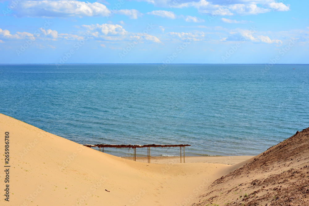 Kapchagay lake shore with beach shelter