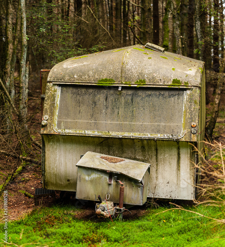 Photography An abandoned caravan in the middle of the woods.