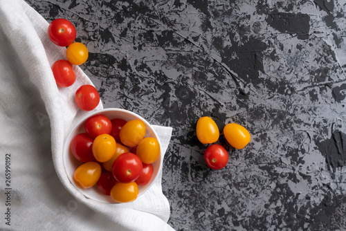 cherry tomatoes and yellow plum tomatoes on a grunge table, tomato diet ,vegetarian menus