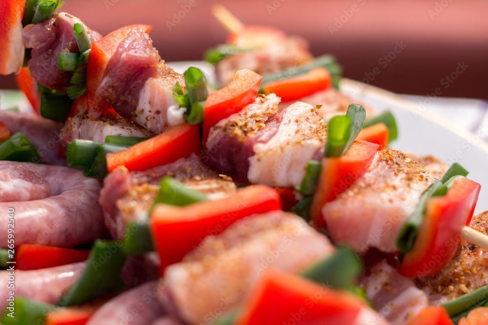 Close up pf delicious chicken breast on wooden skew with fresh vegetables, garlic, paprika fried on mangal barbeque grill and smoke Close up pf delicious chicken breast on wooden skew with fresh vegetables, garlic, paprika fried on mangal barbeque grill and smoke