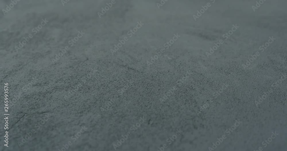 Slow motion shot of decorative dark concrete surface, shot handheld Slow motion shot of decorative dark concrete surface, shot handheld
