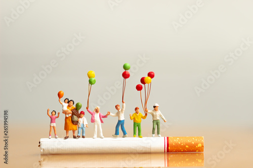 World no tobacco day. Cigarette and family figure. a concept for stop smoking. Smoking a cigarette can kill everyone in family. Save family from smoking. Smoke cigarettes hurt people in the family. photo