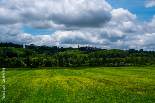 Colorful view of mountain scenery in countryside of France with fresh green meadows on a beautiful day after a summer thunderstorm with a cloudy sky. Eco tourism.