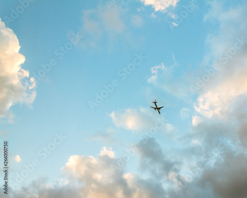 airplane in the sky looking up view sky clouds