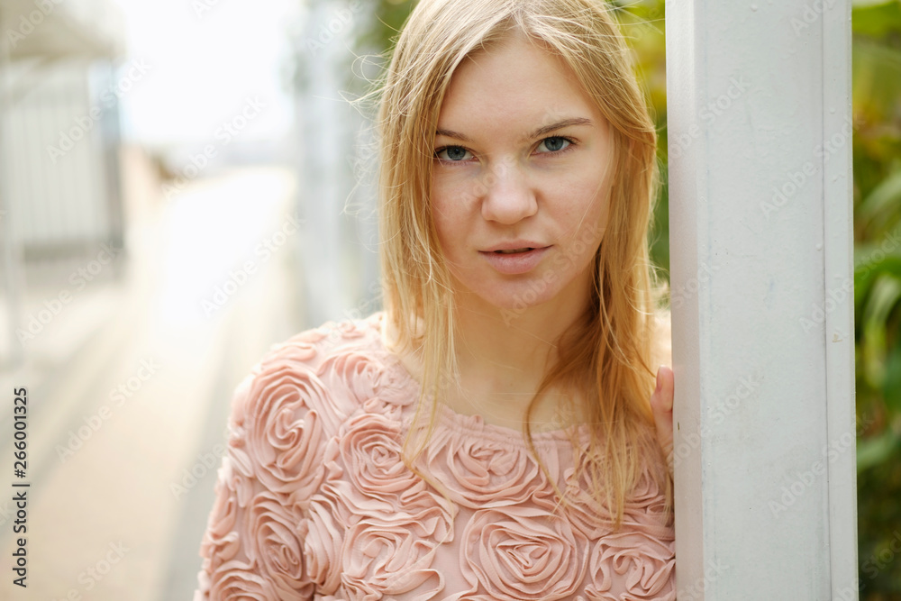 Beautiful blond girl posing for photo at the street Beautiful blond girl posing for photo at the street