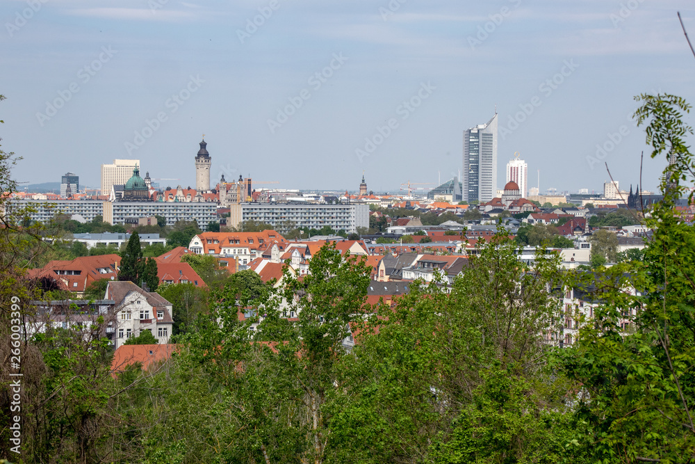 Fototapeta premium Panorama of the city of Leipzig with views of the new city hall, city skyscraper, monument to the Battle of the Nations.Taken from the mountain Fockeberg