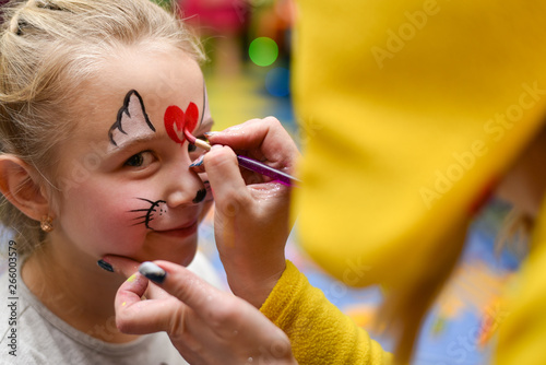 The animator paints the face of the child