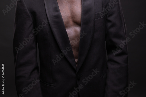 Beautiful and muscular black man in dark background.