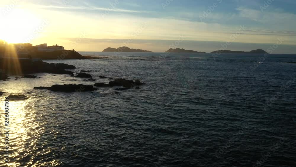 Aerial view of rocky coastline in O Vao beach on spectacular sunset golden hour in Vigo, Pontevedra, Spain. Dolly left shot. Aerial view of rocky coastline in O Vao beach on spectacular sunset golden hour in Vigo, Pontevedra, Spain. Dolly left shot.