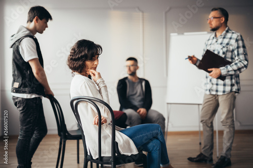 Sad woman lost in thought during meeting with social advisor