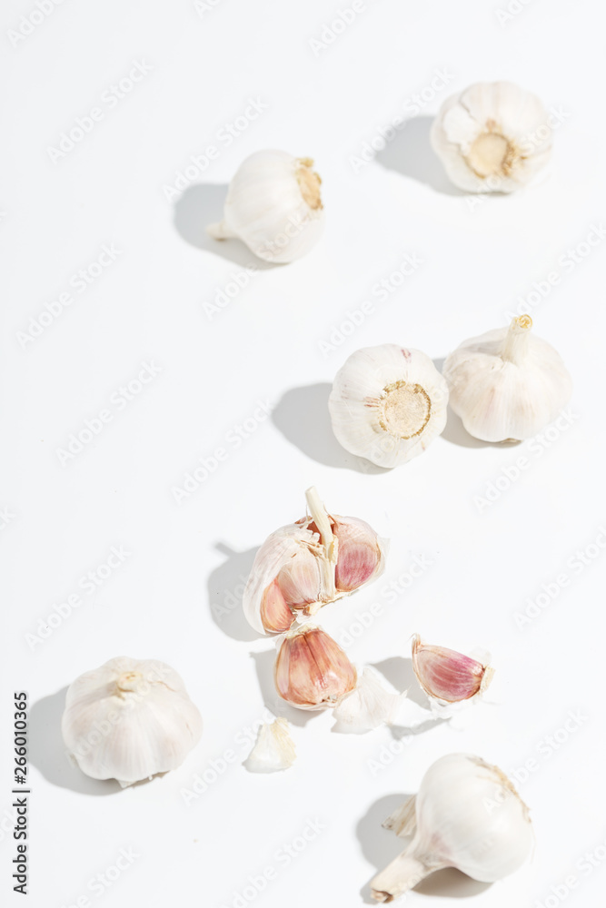 A few heads of garlic on a white background. Top view. A few heads of garlic on a white background. Top view.