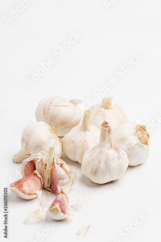 A few heads of garlic on a white background. Top view.