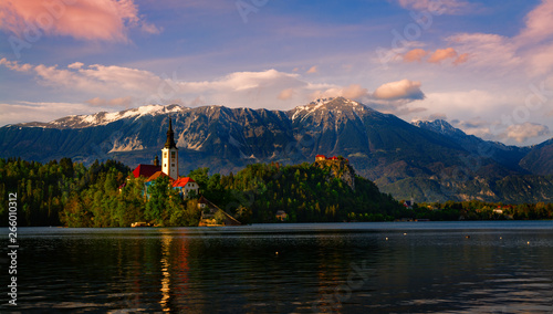 Lake Bled (Slovenia) at sunset, on the foreground the island with the church of the assumption of Mary, on the background the Bled Castle and the snowcapped Julian alps © Alberto Agnoletto