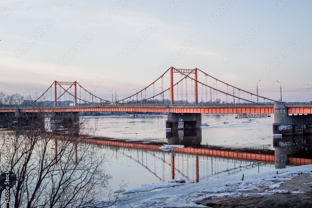 Ice drift in Arkhangelsk on the river.  evening, sunset, bridge, car