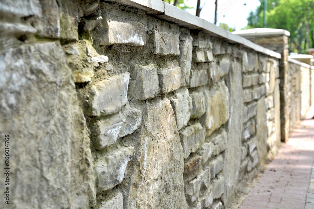 long massive stone fence in the park long massive stone fence in the park
