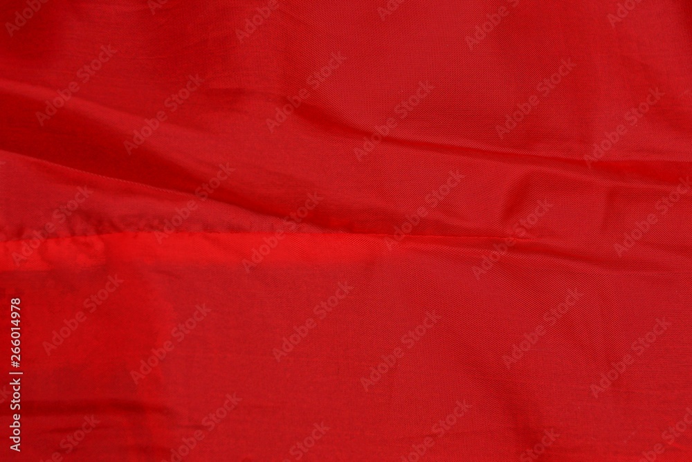 red fabric texture from a piece of crumpled cloth on clothes