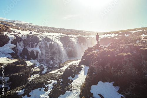 Woman enjoying the beautiful Kolugljúfur Canyon and waterfall, in Iceland