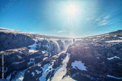 Woman enjoying the beautiful Kolugljúfur Canyon and waterfall, in Iceland photo