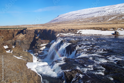 The beautiful Kolugljúfur Canyon with a waterfall and a rainbow, in Iceland