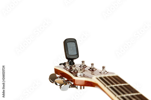 Hand tuning acoustic guitar with electronic tuner