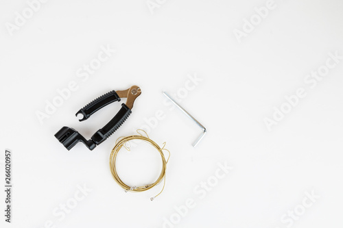Tools for acoustic guitar strings change on a white background, top view