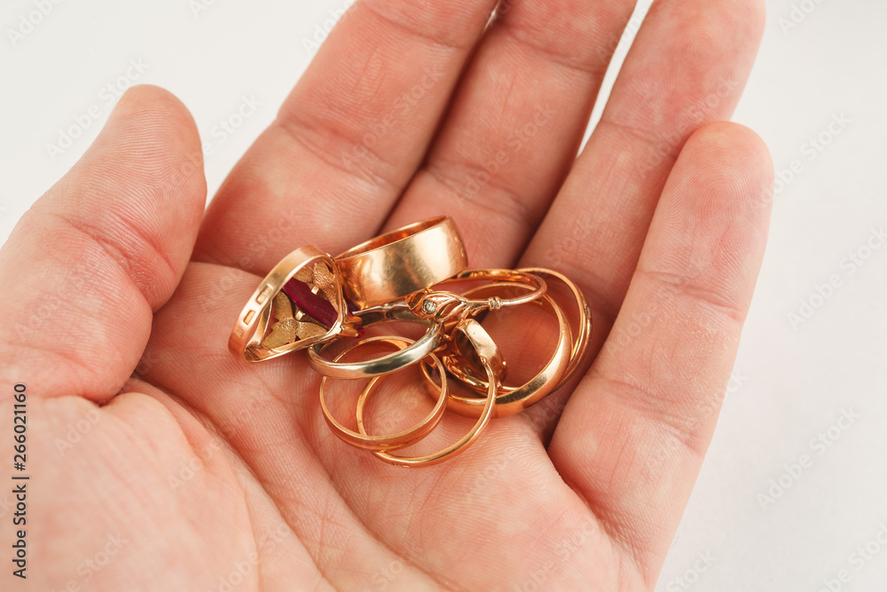 Pile of gold jewellery in hand, closeup shot