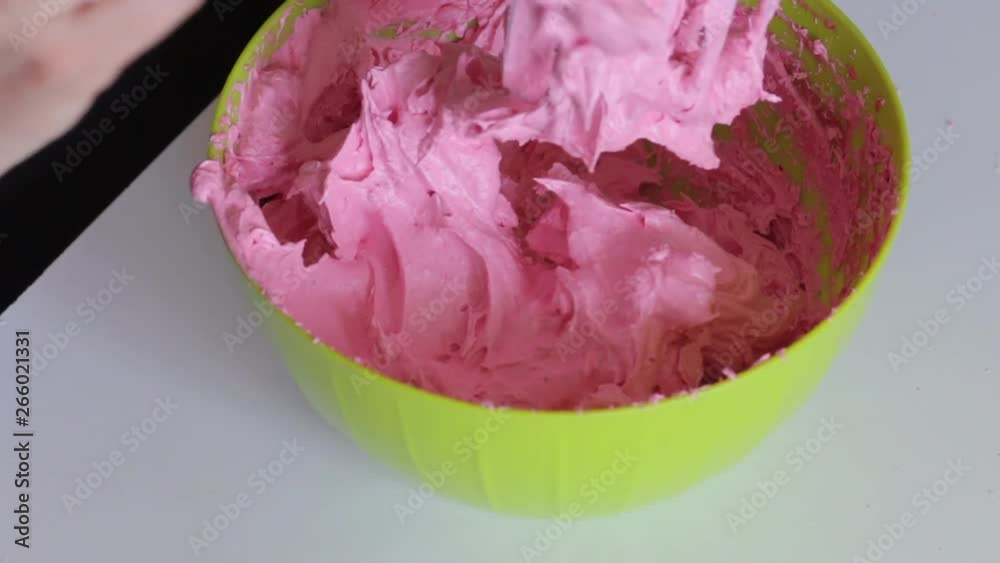 Woman cleans the blender from cranberry puree for marshmallow. Woman cleans the blender from cranberry puree for marshmallow.