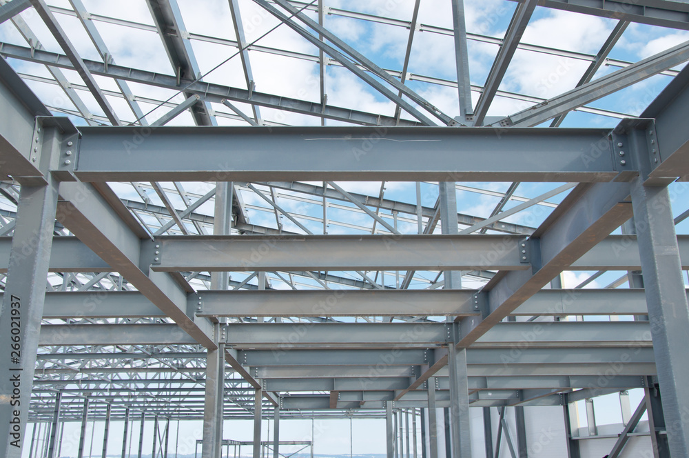 Metal frame of the new building against the blue sky with clouds Metal frame of the new building against the blue sky with clouds