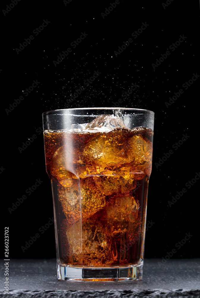 glass of cola with ice on black background - obrazy, fototapety, plakaty 