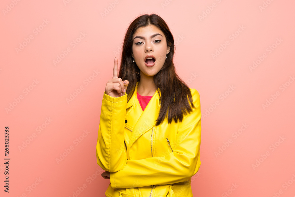 Teenager girl over pink wall thinking an idea pointing the finger up Teenager girl over pink wall thinking an idea pointing the finger up