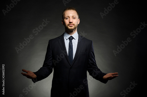 fine portrait of a white man with a beard in a business suit on a black background