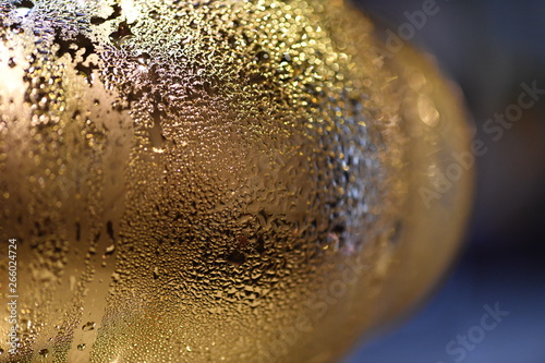 Water drops on a cool golden beer pull.