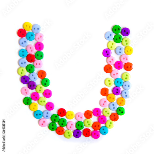 Letter U of the English alphabet made of multi-colored buttons