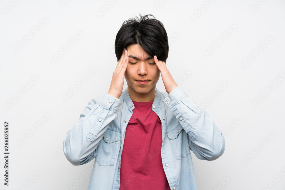 Asian man on isolated white background with headache Asian man on isolated white background with headache