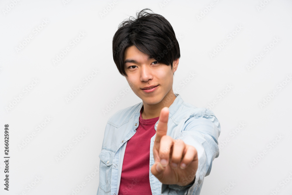 Asian man on isolated white background showing and lifting a finger Asian man on isolated white background showing and lifting a finger