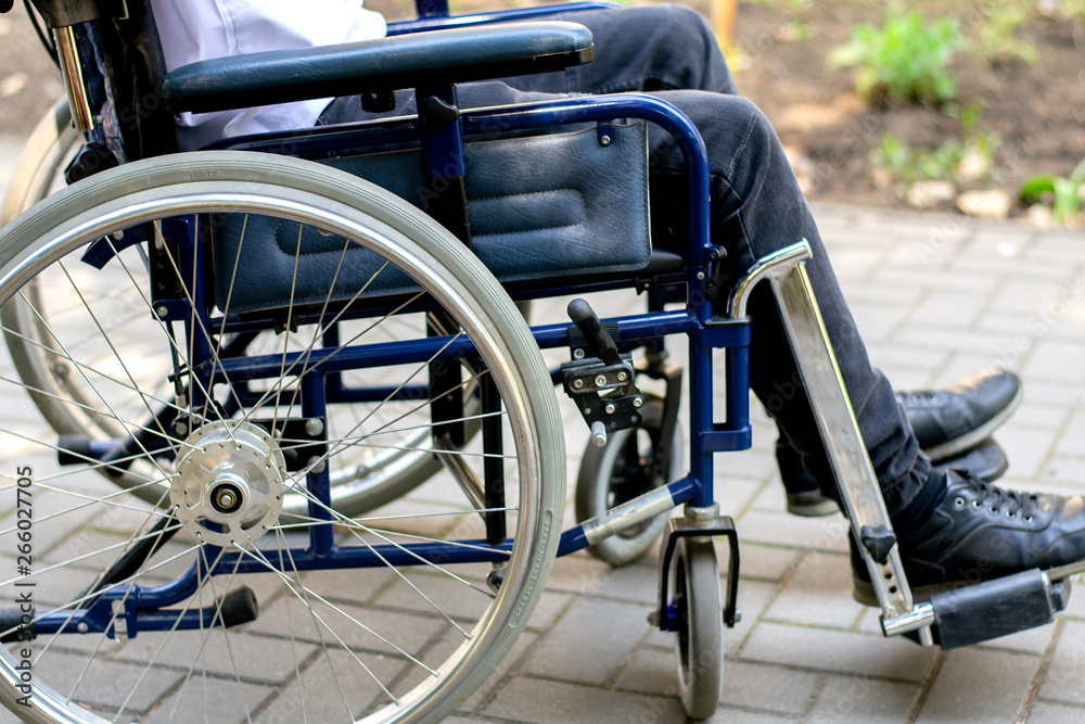 disabled person in a wheelchair on the street a young guy in a wheelchair disabled person in a wheelchair on the street a young guy in a wheelchair