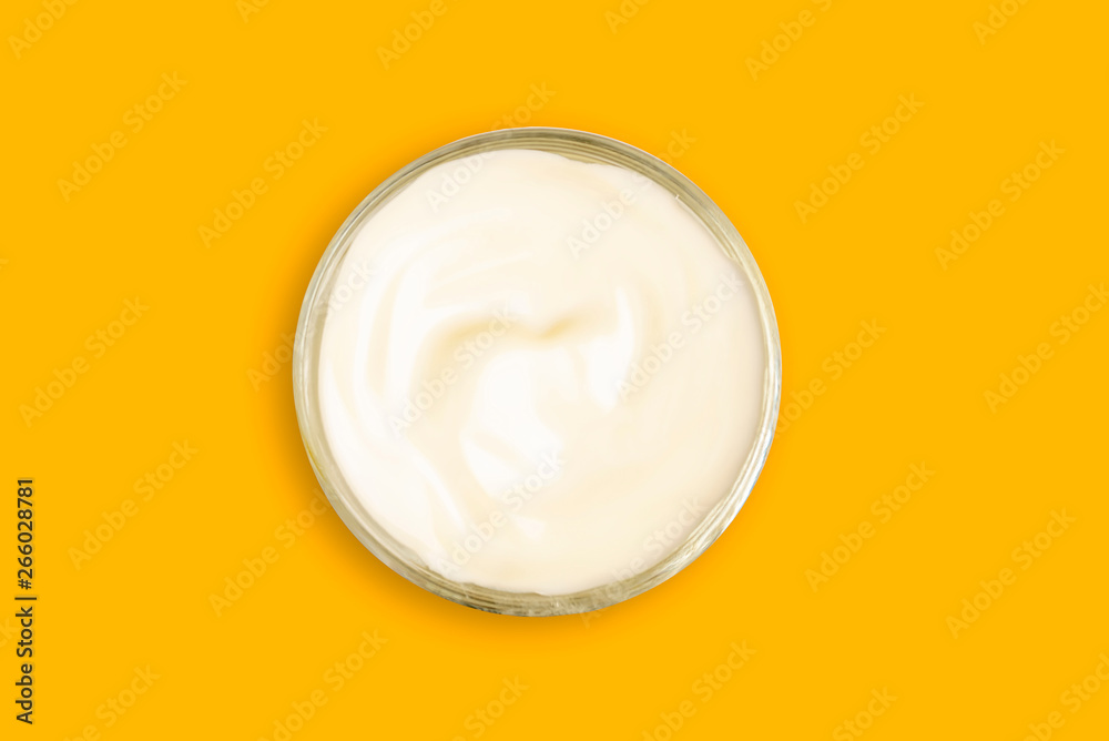Spa cream in a glass cup placed on a Yellow background. Cosmetic cream camomile. Organic cosmetics with coconut on Isolated Yellow background top view. Spa cream in a glass cup placed on a Yellow background. Cosmetic cream camomile. Organic cosmetics with coconut on Isolated Yellow background top view.