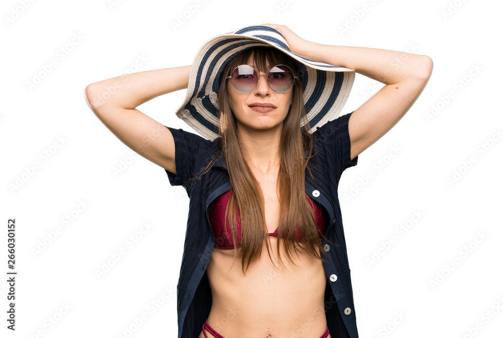 Young woman in bikini with surprise facial expression over isolated white background