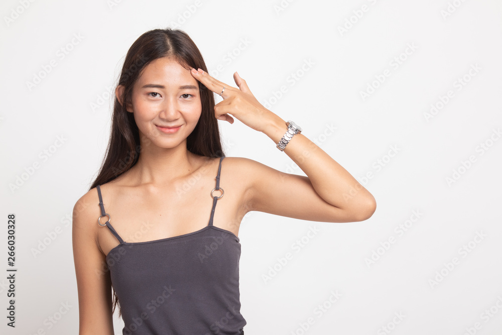 Beautiful young Asian woman holding fingers in gun gesture. Beautiful young Asian woman holding fingers in gun gesture.