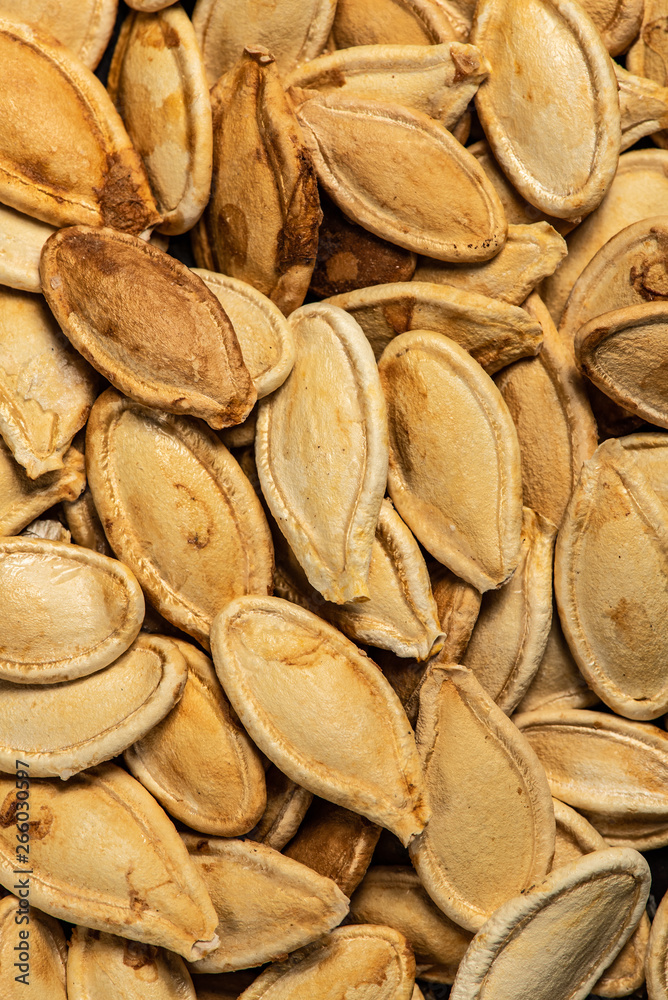 Roasted pumpkin seeds, cooked in oven, macro look Roasted pumpkin seeds, cooked in oven, macro look