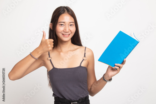 Young Asian woman thumbs up with a book.