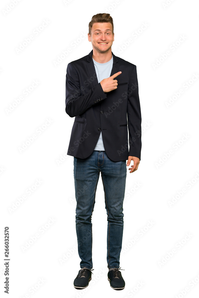 Blonde handsome man pointing to the side to present a product Blonde handsome man pointing to the side to present a product