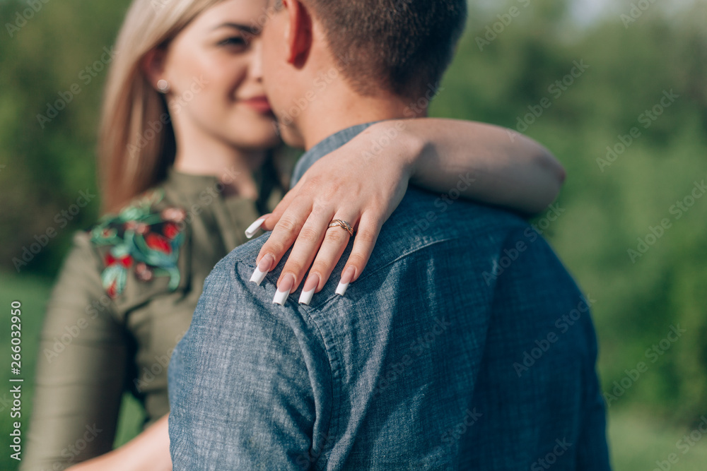 Fototapeta premium Attractive Funny Couple outdoor.stylish couple in love hugging on a walk in spring.young couple in love having fun and enjoying in the nature.concept of love story