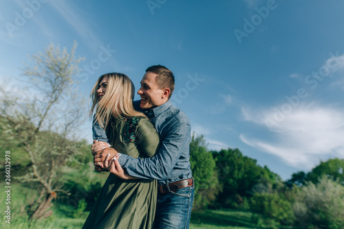 family weekends outside the city.stylish couple in love hugging on a walk in spring.young couple in love having fun and enjoying in the nature.concept of love story
