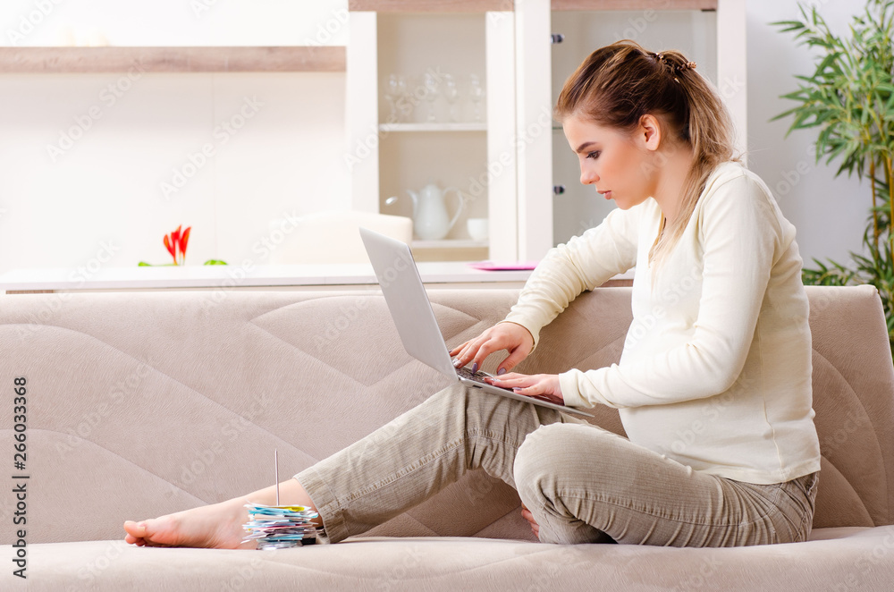 Young pregnant woman in budget planning concept Young pregnant woman in budget planning concept