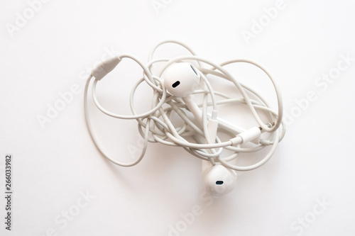 headphones on a white background the wires of the headphones are tangled