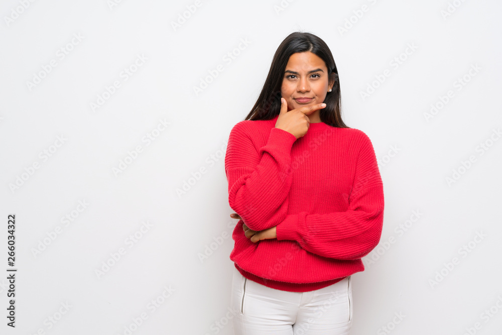 Young Colombian girl with red sweater thinking