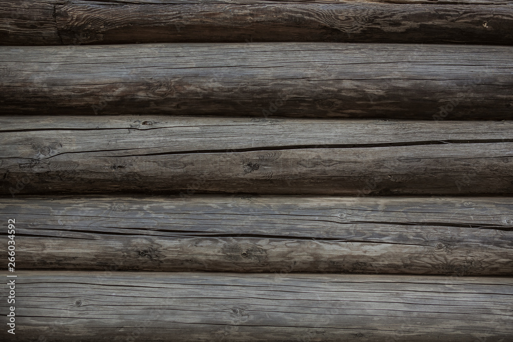 Fragment of old weathered log wall, natural grey horizontal background texture detail close up