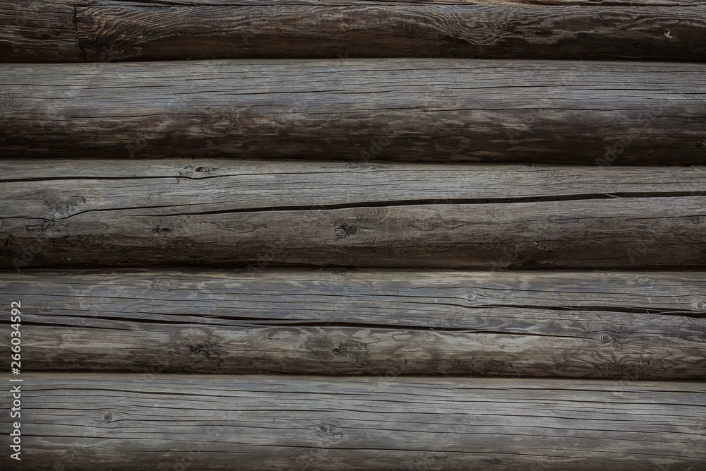 Fragment of old weathered log wall, natural grey horizontal background texture detail close up Fragment of old weathered log wall, natural grey horizontal background texture detail close up